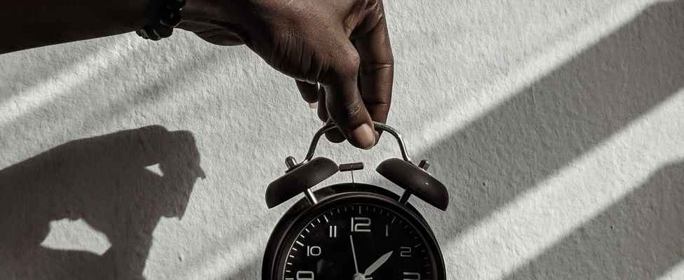 person holding a alarm clock